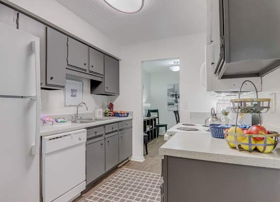 A kitchen with a white refrigerator and a white washing machine.