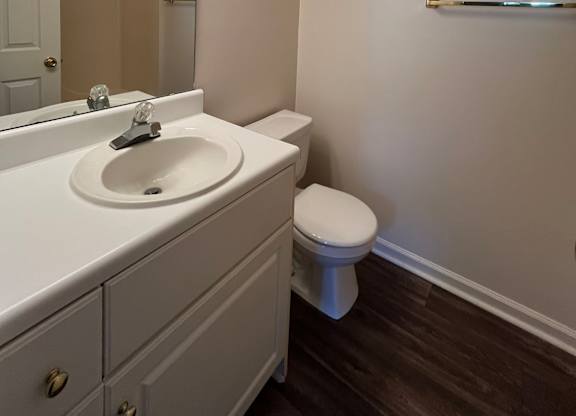 A white bathroom with a toilet and sink.