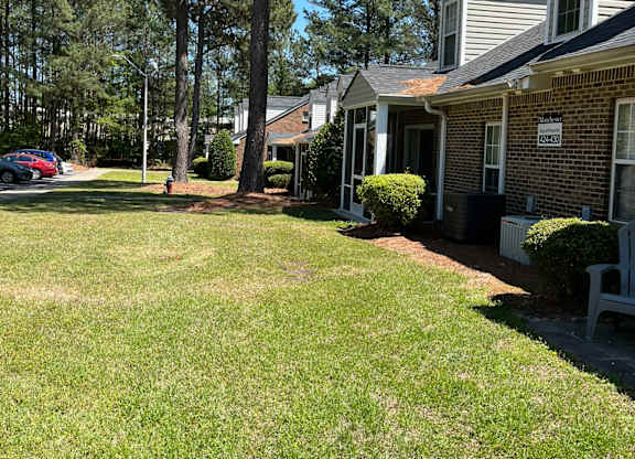 A residential area with houses and green grass.