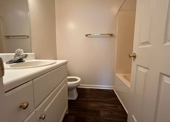 A white sink and toilet in a small bathroom.