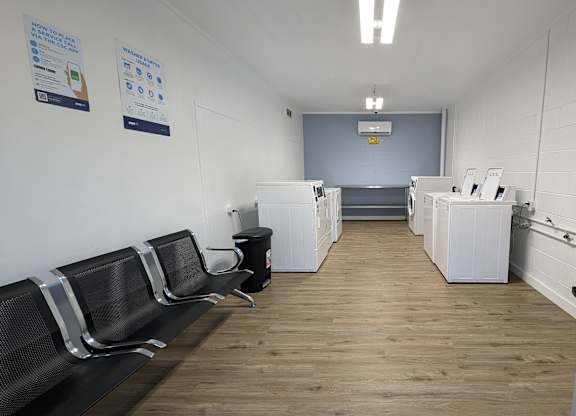 a break room with chairs and counters and a door