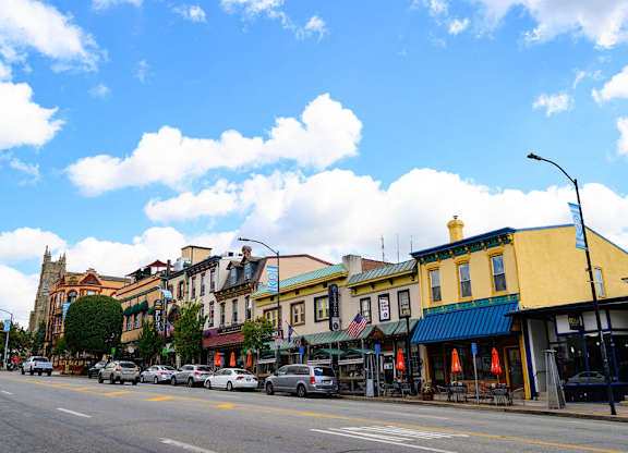 a city street with cars parked in front of buildings