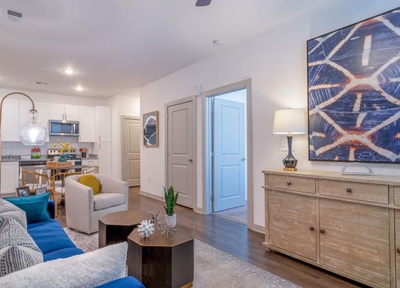 a living room and kitchen with a blue door at Carmel Vista, McDonough, GA, 30253
