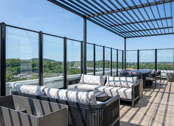 a terrace with couches and tables on a roof