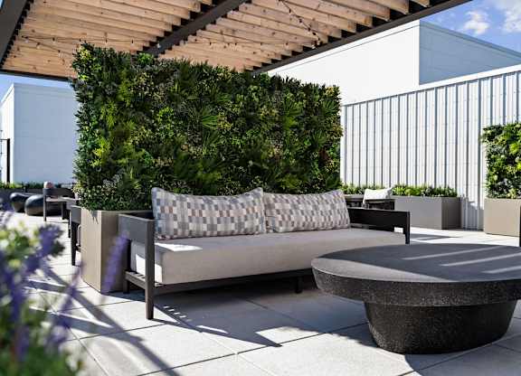 a seating area with a couch and a table on a patio