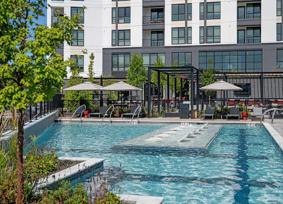 a swimming pool with a building in the background