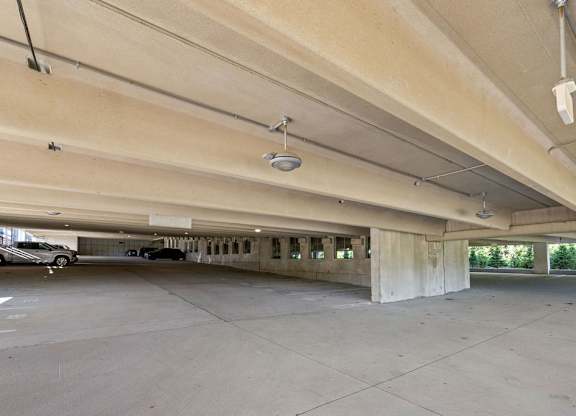 an empty parking garage with cars parked in it