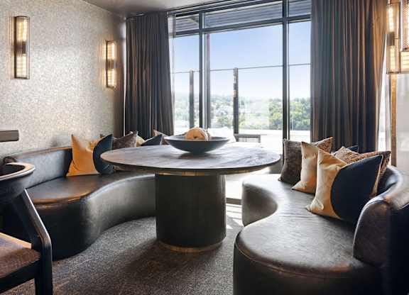 a living room with couches and a table with a bowl