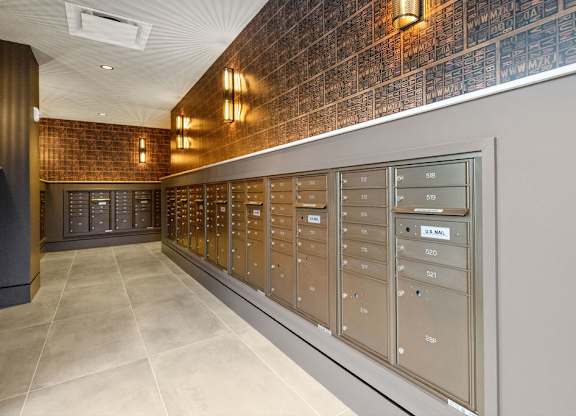 the mail room in the building is full of mailboxes
