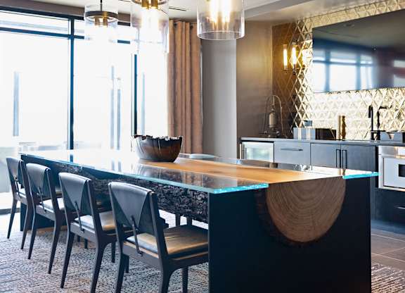 a large kitchen with a long table and chairs