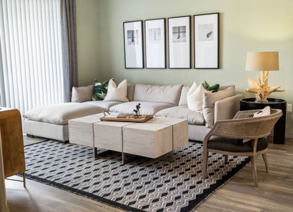 a living room with a couch and a table at Inspira, Naples, FL, 34113