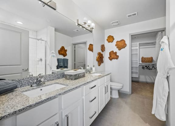 a bathroom with a sink and a toilet and a mirror at Inspira, Naples, 34113