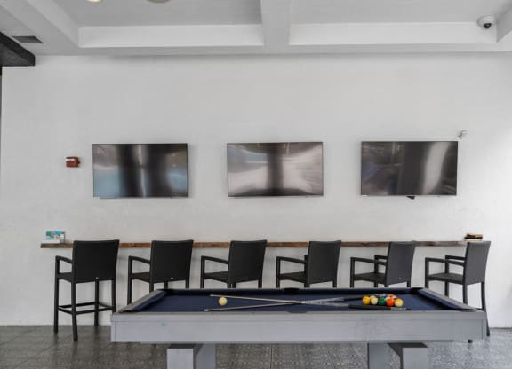 a pool table and chairs in a room with pictures on the wall at Inspira, Florida, 34113