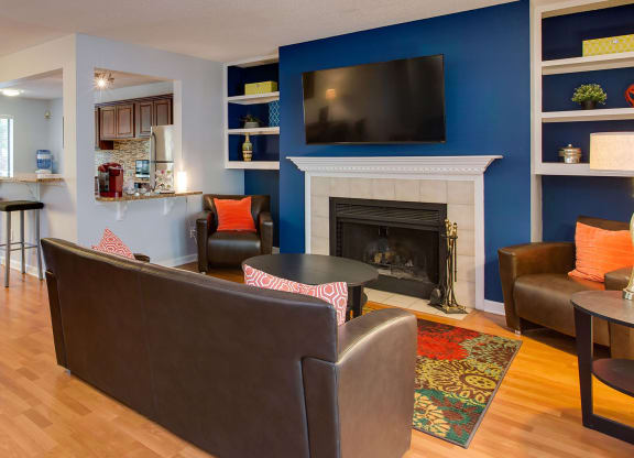 Resident lounge with fireplace, seating and kitchen with coffee station at Laurel Oaks, Raleigh, NC, 27613