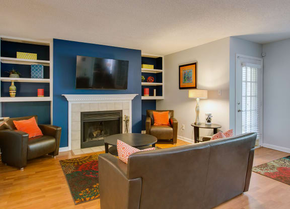Resident Lounge with fireplace, seating, tv at Laurel Oaks, Raleigh, North Carolina