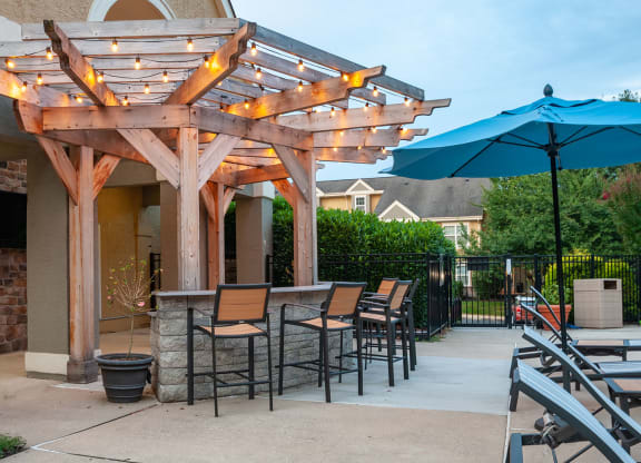 Pool Bar with TV at dusk with the lights on at Madison Glen Mills, Glen Mills, PA