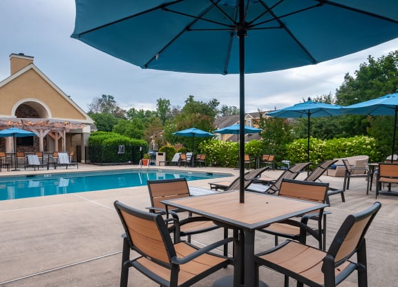 table and chairs under umbrella at the pool at Madison Glen Mills, Glen Mills, Pennsylvania