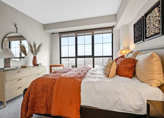 a bedroom with a large bed and a window
