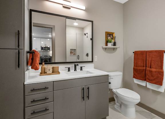 a bathroom with a sink toilet and a mirror