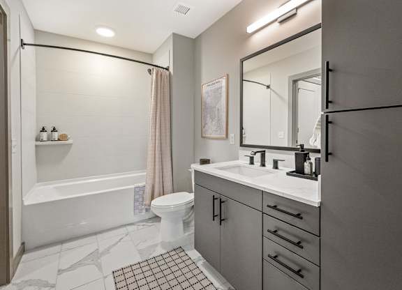 a white bathroom with a shower and a sink
