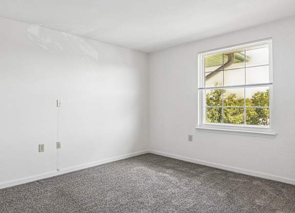 A room with a window and a door.