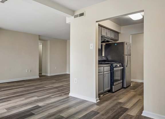 A kitchen area with a refrigerator, oven, and microwave.