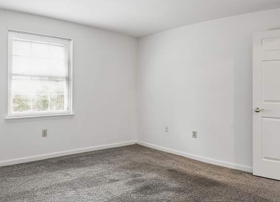 A room with a window and a door.