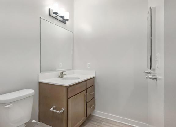 A white toilet sits next to a sink in a small bathroom.