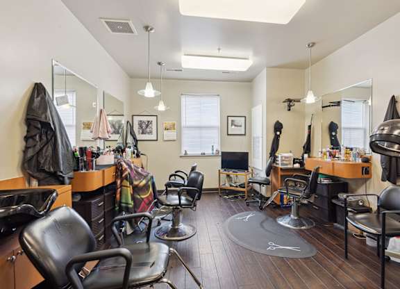 a salon room with chairs and mirrors