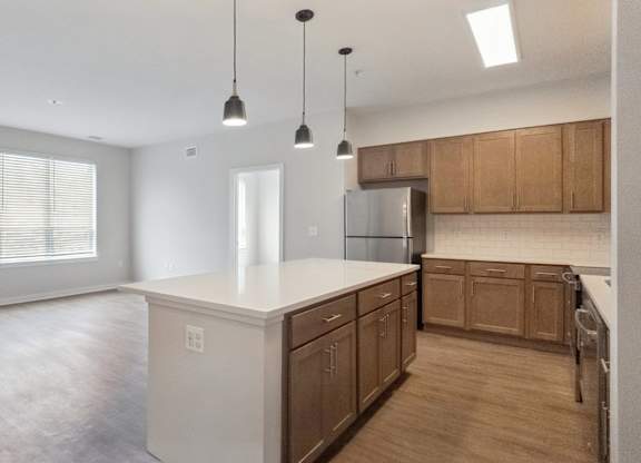 A kitchen with wooden cabinets and a white countertop.