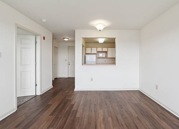 A room with wooden floors and white walls.