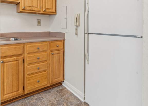 Kitchen with refrigerator, stove, and cabinetry in Towson senior housing