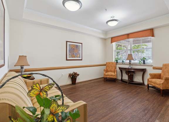 a living room filled with furniture and a large window