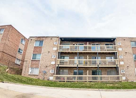 Apartment building with a balcony on the second floor.