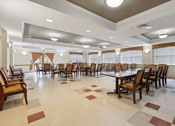 a large dining room with a large table and chairs