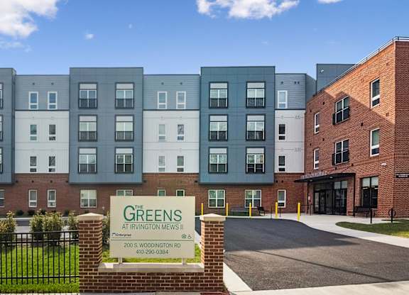 The image shows a building with the name GREENS on it.