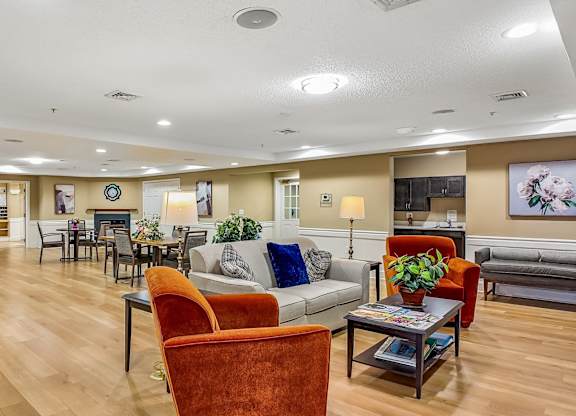 A living room with a couch, chairs, and a coffee table.