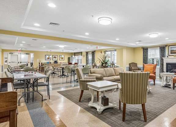 A spacious living room with a dining table and chairs.