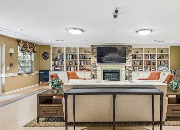 A living room with a fireplace and a bookshelf.