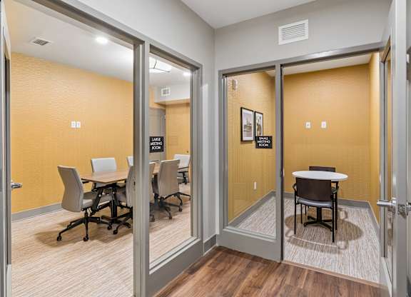 A conference room with a table and chairs.
