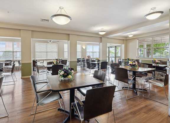 a large dining room with tables and chairs