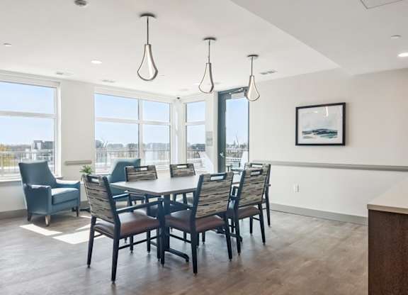 A dining room with a table and chairs.