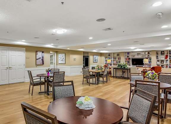 A dining room with a fireplace and a table set for a meal.