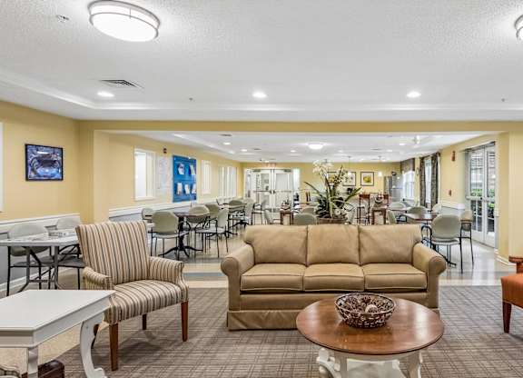 A living room with a couch, chairs, and a coffee table.
