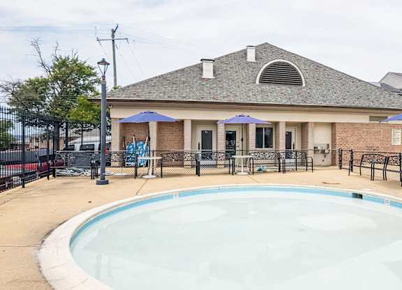 A small pool in front of a house.