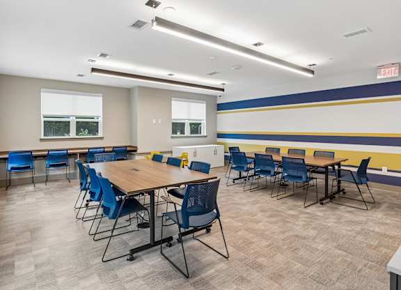 A conference room with a long table and chairs.