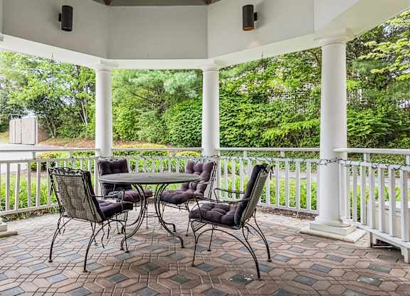 A patio with a table and chairs.