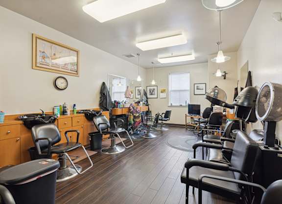 a room with a lot of chairs and a clock on the wall