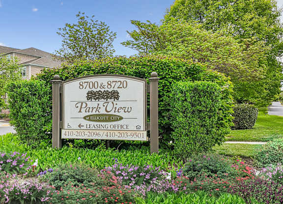 A sign for Park View Leasing Office is surrounded by greenery.