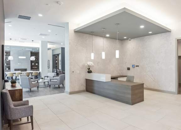 A reception area with a counter and chairs.
